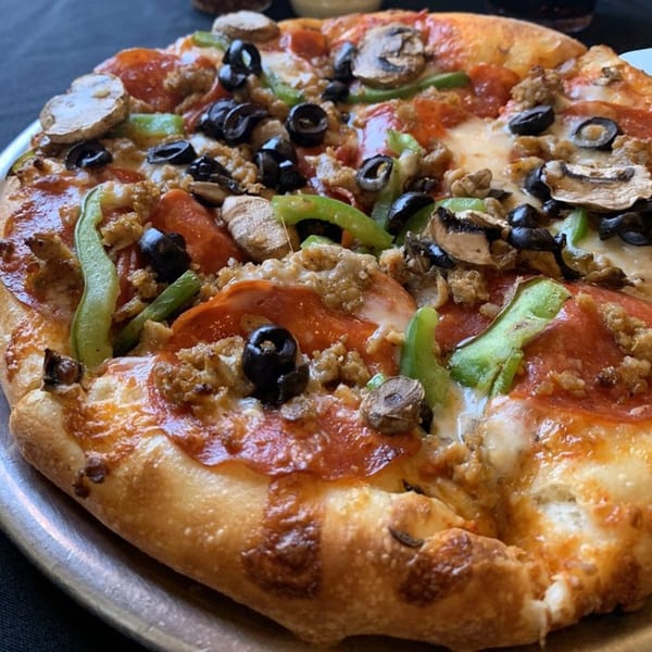 Angelo's West pizza with pepperoni, sausage, mushrooms, green peppers, and black olives.